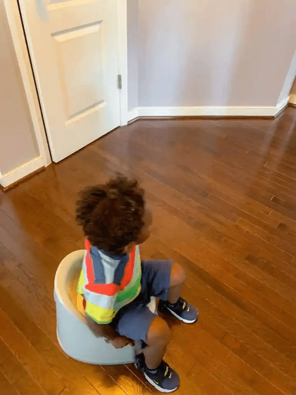 Toddler sitting on potty chair for potty training.