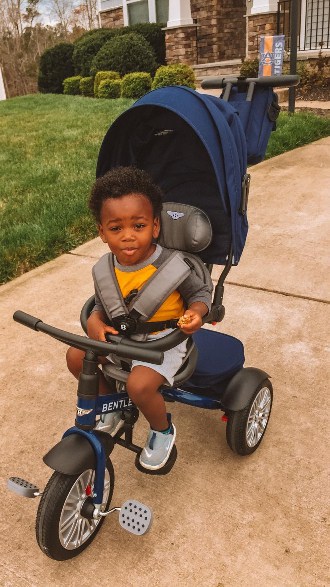 Toddler on his Bentley trike in blue.