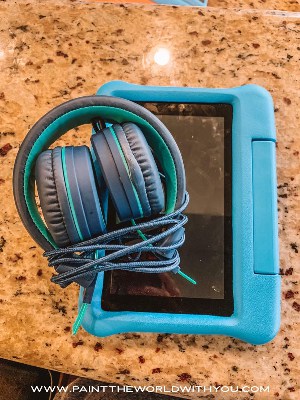 Amazon fire and headphones are travel essentials for toddlers.