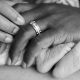 new parents holding baby feet in the hospital