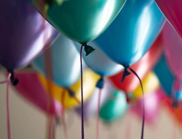 Colorful balloons with string hanging.