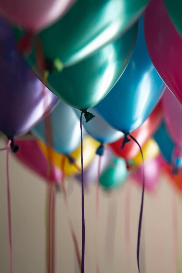 Colorful balloons with string hanging.